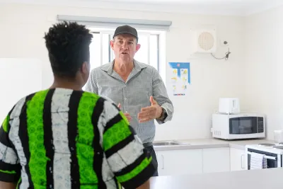 Corrections Minister standing in the kitchen of one of the units.
