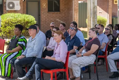 Crowd sitting outside to watch the Welcome to Country.
